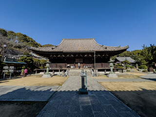 Fototapeta premium Chozuya Purification Fountain at Japanese Temple with Statues, Taisanji Temple, 52 of 88, Ehime, Japan