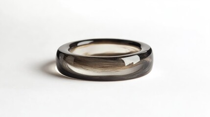 A smoothsmoky gray wood resin ring with sleek resin details, set against a clean white background