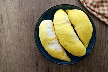 Fresh Durian in blue plate on wooden background, , top view food table, fruit