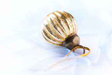 Christmas golden bauble on bright background. Close up. Copy space.	