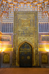 Portal and arch inside the tilya kori mosque in the Registan of Samarkand, with gold and blue details