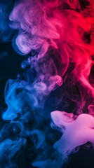 Fototapeta premium Abstract blue and pink smoke swirls on a black background.