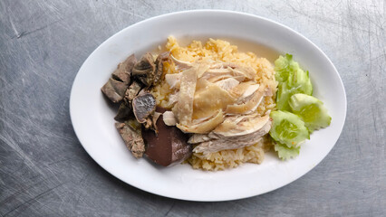 Chicken rice in a white plate on the dining table