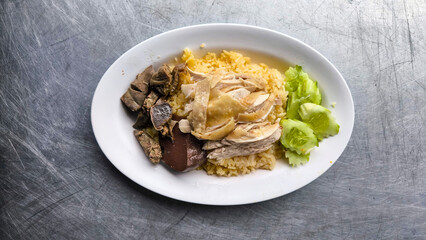 Chicken rice in a white plate on the dining table