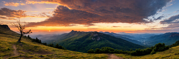 Fototapeta premium Golden hour sunset over a mountain landscape with panoramic views and calm orange skies, creating a peaceful and serene atmosphere ideal for capturing the beauty of nature during a relaxing summer eve