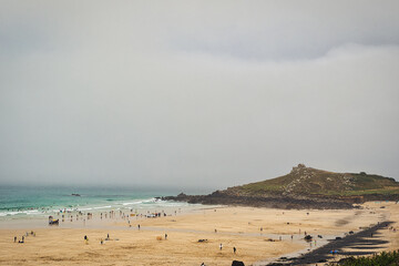 Serene Beach Scene with People and Cloudy Sky in St Ives, Cornwall, UK