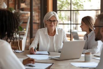 Fototapeta premium Mature Businesswoman Leading Boardroom Discussion