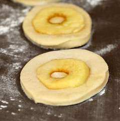 Apple rings on a board before baking