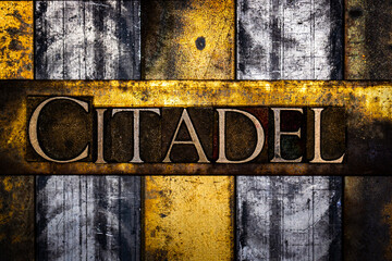 Citadel text in real authentic typeset letters on vintage textured silver grunge copper and gold background