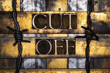 Cut Off text with barbed wire in real authentic typeset letters on vintage textured silver grunge copper and gold background 