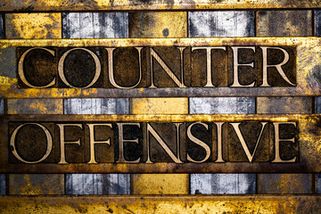 Counter Offensive text in real authentic typeset letters on vintage textured silver grunge copper and gold background