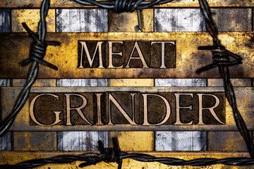 Meat Grinder text with barbed wire in real authentic typeset letters on vintage textured silver grunge copper and gold background