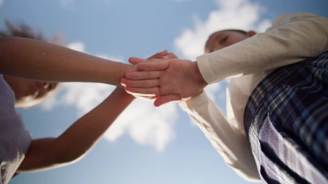Bottom view two schoolgirls friends little girls school students children multiethnic female kids daughters pupils primary education class unity teamwork putting hands stack together connect outdoors