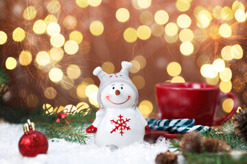 Cute snowman in Christmas composition against blurred lights, bokeh effect. Space for text