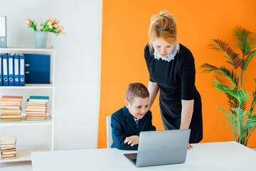 Little boy boss and business secretary in the office