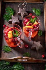 Sweet Christmas punch with orange, cranberry and cinnamon,