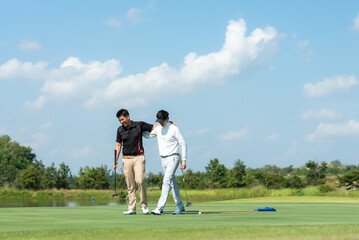 Group golf professional Golfer asian man walking in fairway with bag golf at golf  club.  Hobby in holiday and vacation with friends.  Lifestyle and Sport Concept