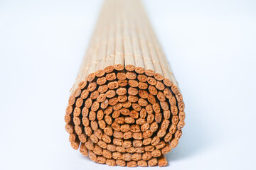 a roll of bamboo mat on white background 