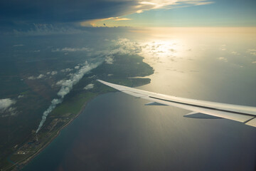 Serene airplane view over coastal landscapes at sunset