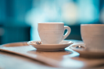 Steamy cup of coffee on table in cozy cafe