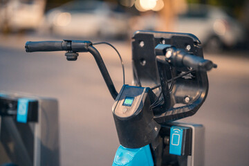 Electric scooter docked at charging station