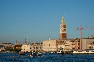 grand canal at sunset with the tower of piazza San Marco and boat in first plane