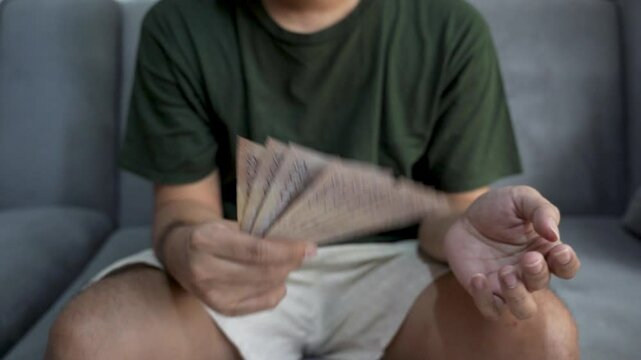 Close up of Asian man's hand counting Vietnamese dong currency