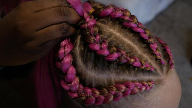 Afro braiding - pink braids. Creativity and fashionable hairstyle concept. African braids for girl