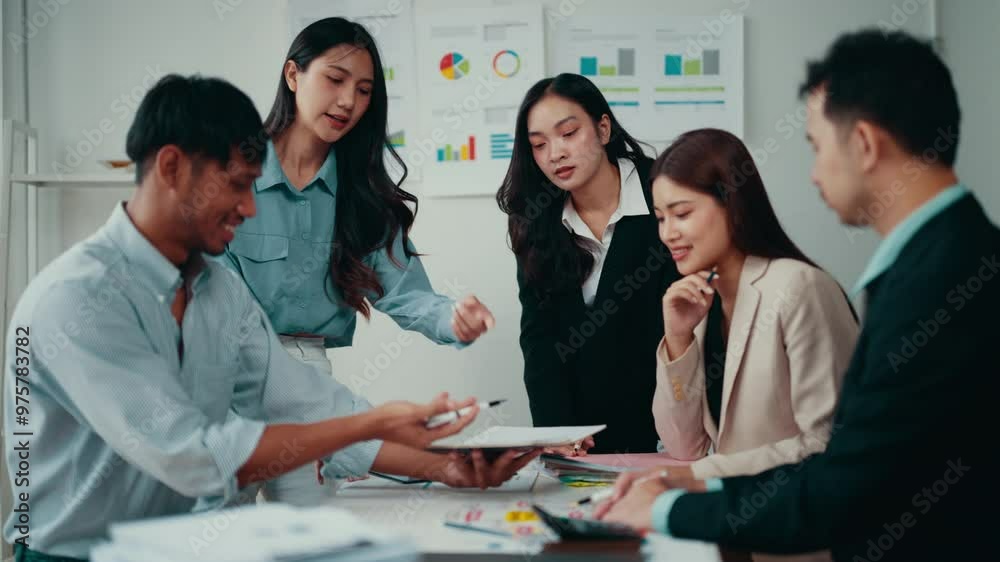 Poster marketing team is having a discussion in their office. they are working together, using a digital ta