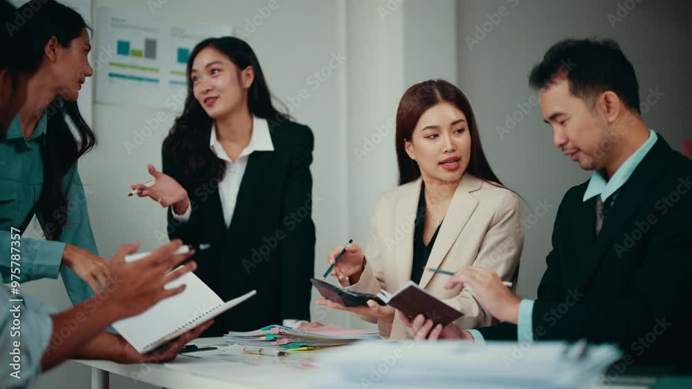 Poster Team of four asian businesspeople are discussing financial data. One woman is calculating numbers while the others are analyzing reports and brainstorming solutions
