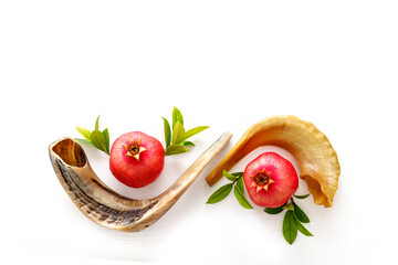 Shofar and pomegranate on white background. Rosh Hashanah holiday concept. Top view