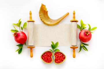 Jewish holiday Rosh Hashanah concept. Banner with Pomegranates, shofar and torah. Top view. Space...