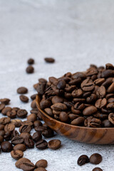 coffee beans in wooden bowl on concrete table