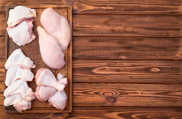 Raw mixed chicken meat parts  for cooking on rustic background