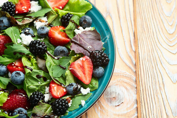 Berries salad (blueberry strawberry blackberry ) with cheese feta and balsamic sauce