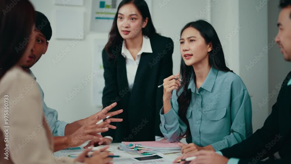 Poster Business teams engage in a meeting within an office setting, discussing work-related topics and gesturing to emphasize points, fostering collaboration and communication