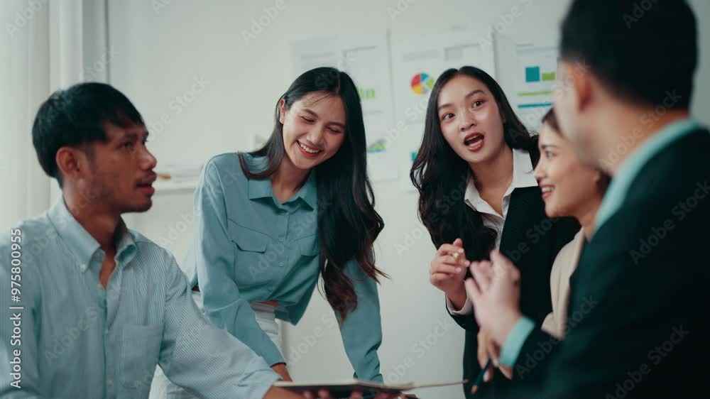 Poster four asian coworkers are discussing business strategy around a table in a brightly lit office. they 