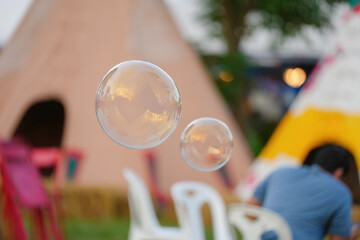 Soap bubbles with view in the amusement park.