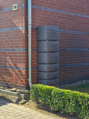 Obraz premium rainwater barrel at the facade of a building