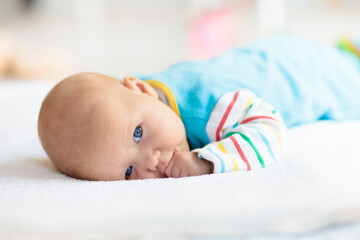 Little baby on white bed