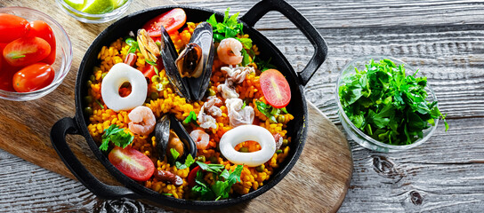 Seafood paella served in a cast iron pan