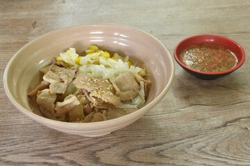 Korean fried slice pork with cabbage and glass noodles on bowl dipping spicy sauce