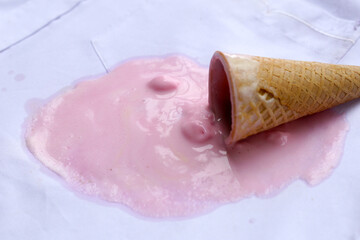 Iice cream with waffle cone on a white shirt, dirty stain