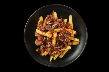 Delectable dish of crispy fries topped with savory meat and rich sauce, served on a sleek black plate, perfect for food lovers