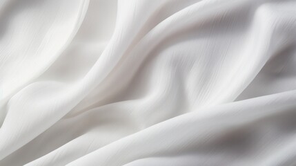 A close-up image of clean, white cotton fabric draped softly, revealing the gentle folds and curves. The surface is immaculate and free of imperfections,