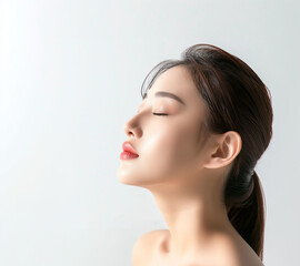 Obraz premium Radiant Close-Up of a Young Asian Woman's Face with Healthy Skin