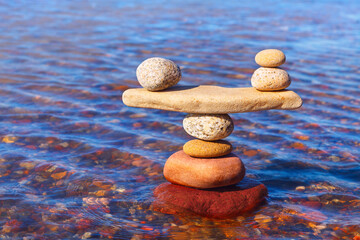 Symbolic scale of the stones on sea background. Concept of harmony and balance. work-life,...