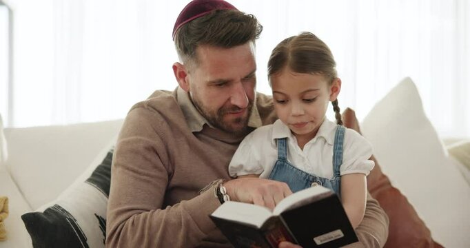 Religion, reading and father with book and girl in home, teaching and learning about Torah and spiritual knowledge. Child, education and sharing Jewish gospel, faith or history of culture on sofa