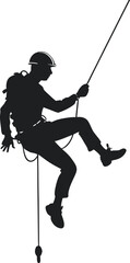 Fototapeta premium Silhouette of a Rock Climber Rappelling Down