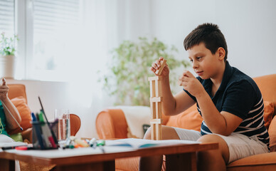 A grandmother lovingly knits a vest while her young nephew concentrates on building with blocks in a cozy home setting, showcasing family bonding and creativity.